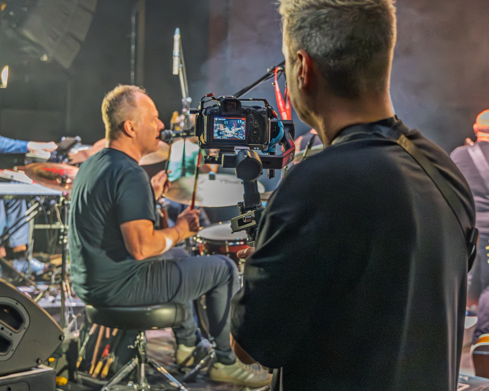 Sam filming the drummer from behind with a gimbal rig